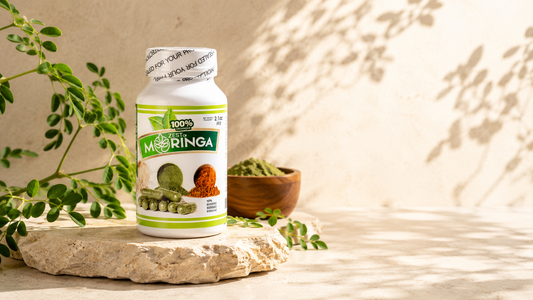 Zest of Moringa Organic Moringa Oleifera Capsules bottle on a natural stone pedestal with fresh moringa leaves and moringa powder.