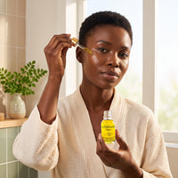 Woman applying Zest of Moringa cold-pressed face oil with the 15 ml dropper